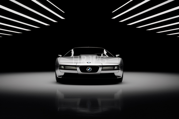 High Resolution: Sleek silver BMW sports car is centered in a minimalist black background with white diagonal light streaks showcasing its sharp headlights and aerodynamic design download. | HRJPG.com