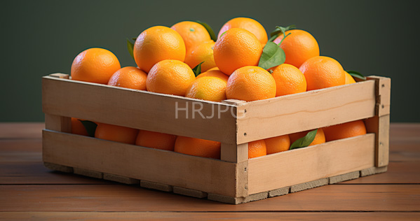 High Resolution: Wooden crate filled with bright orange textured citrus fruits oranges and green leaves on a rustic brown table against a dark olive-green background download. | HRJPG.com
