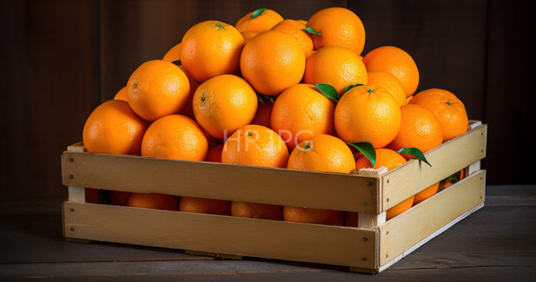 High Resolution: Wooden crate filled with bright orange textured citrus fruits oranges against a dark brown wood background with green leaves attached to the fruit download. | HRJPG.com