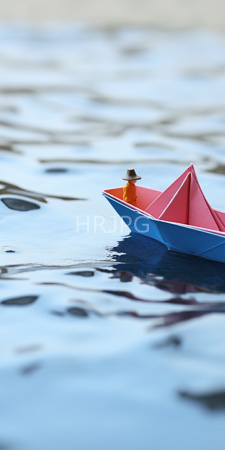 High Resolution: Small colorful paper boat with red triangular sail and blue hull floating on calm water download. | HRJPG.com