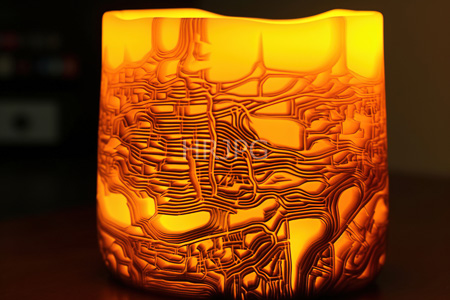 High Resolution: Orange cylindrical glass candle holder with intricate geometric patterns etched into its surface emits warm light from within download. | HRJPG.com