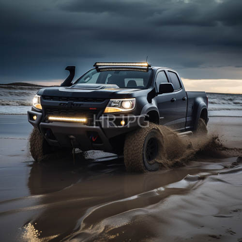ford ranger navigates damp saturated sand at dusk with aggressive stance and illuminated grille