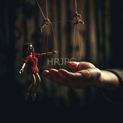 miniature marionette amidst inky void and faint ambient light