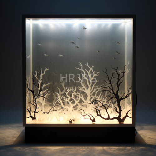 coral branches suspended in led illuminated aquarium display case against light beige sand