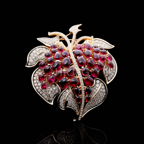 intricately crafted gold leaf brooches with luscious berry clusters and subtle diamond accents