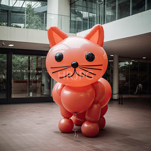 colorful inflatable feline forms tower above city skyline at dawn